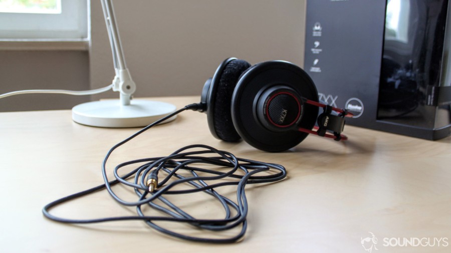 A photo of the AKG K7XX on a desk with the long cable wrapped up in the foreground. 
