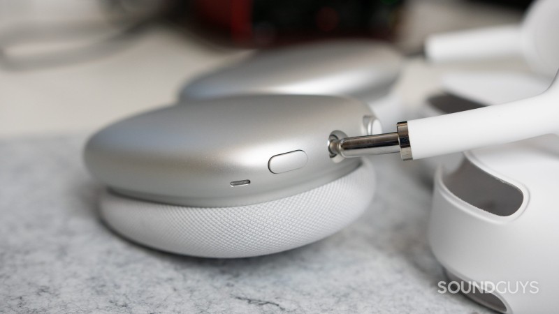 Close-up of the noise cancelling toggle on the Apple AirPods Max as it is on a desk.