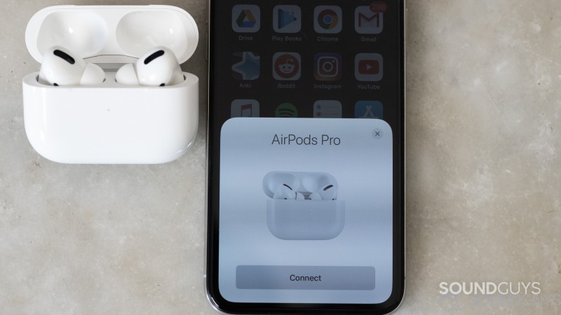 Shot of the open AirPods Pro case along with the pop-up connecting card on an iPhone X 